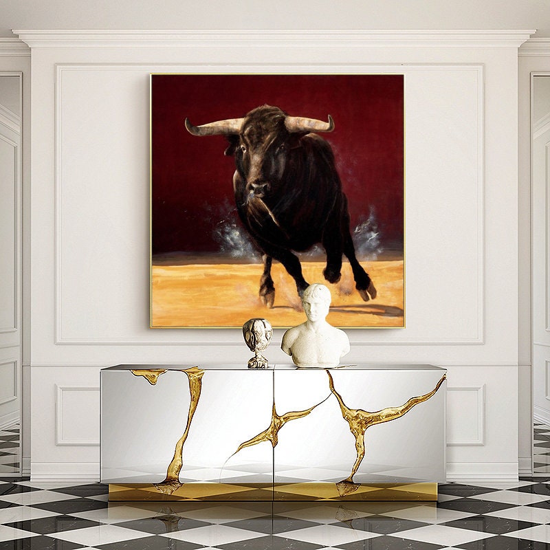 Dynamic Bull Artwork, Running Boldly in Rich Red and Gold Tones